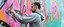 young-guy-gray-hoodie-paints-graffiti-pink-green.jpg.jpeg